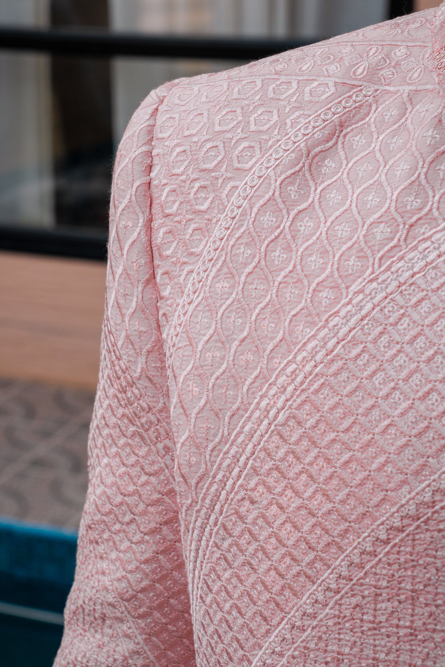 Pastel pink 3-piece prince coat set with textured sequence embroidery and pearl-button detailing on the front. Layered over a pleated pink kurta and matching straight trousers