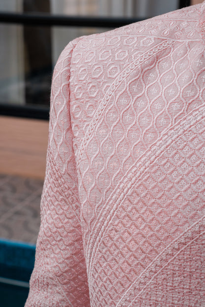 Pastel pink 3-piece prince coat set with textured sequence embroidery and pearl-button detailing on the front. Layered over a pleated pink kurta and matching straight trousers