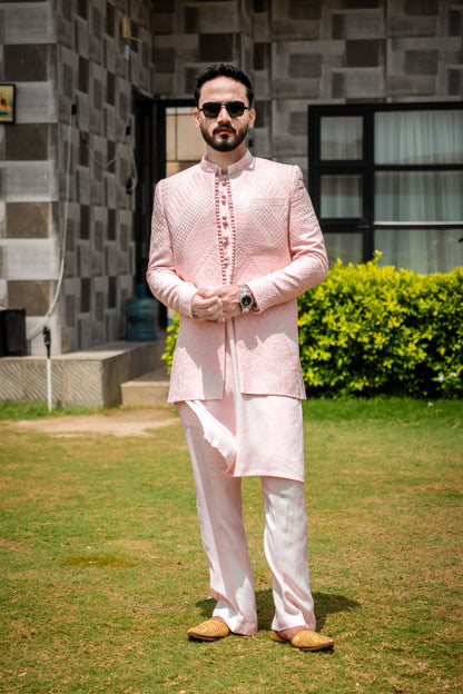 Pastel pink 3-piece prince coat set with textured sequence embroidery and pearl-button detailing on the front. Layered over a pleated pink kurta and matching straight trousers